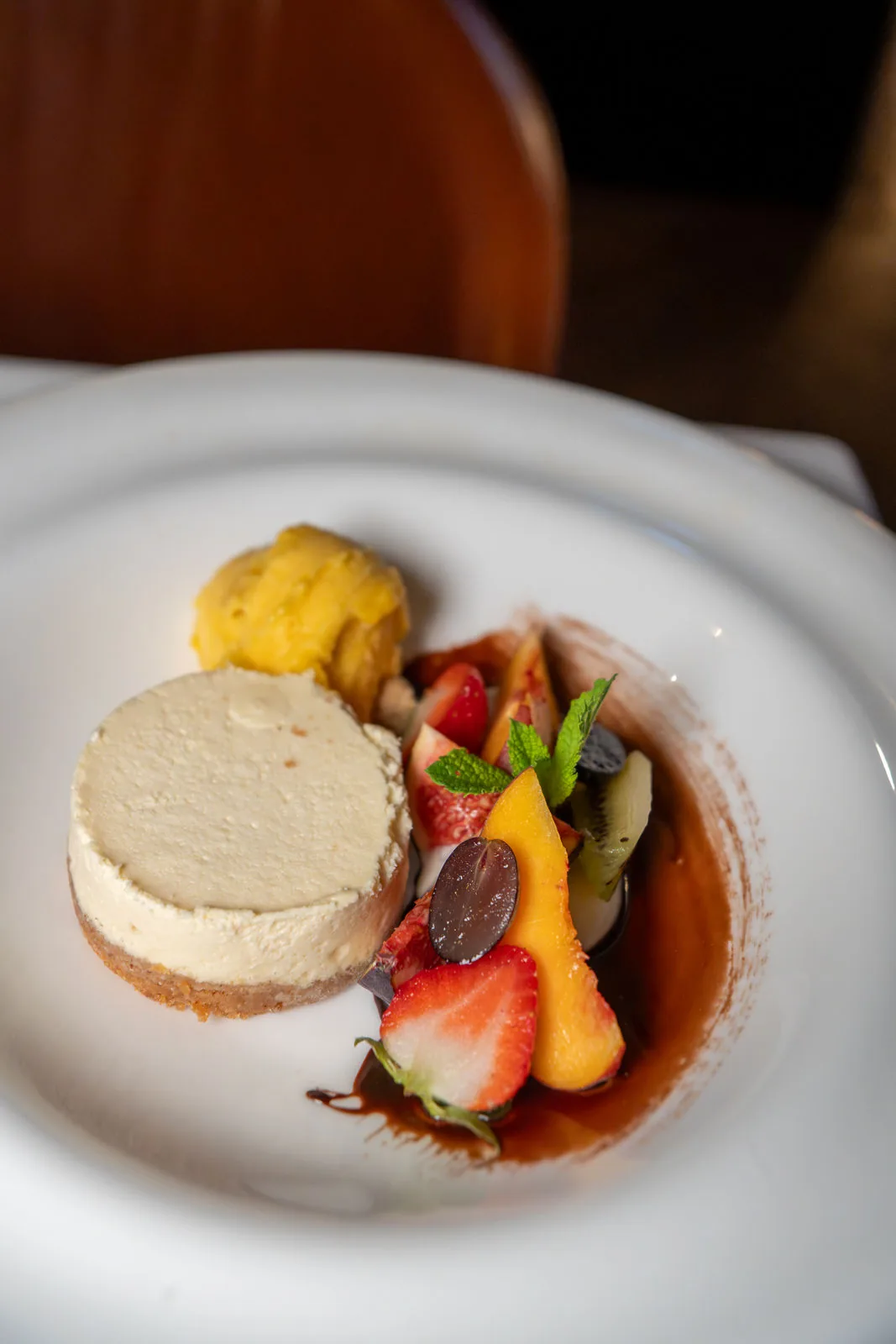 Cheesecake mit frischen Früchten und Schokoladensauce im IVY